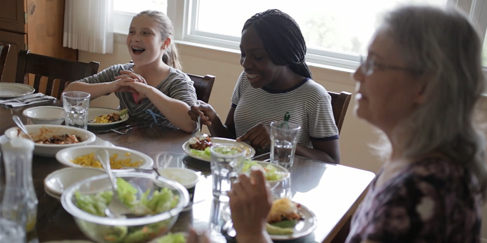 Children sit around a table with an adult. Photo for Masonic Children's Home Renovations.