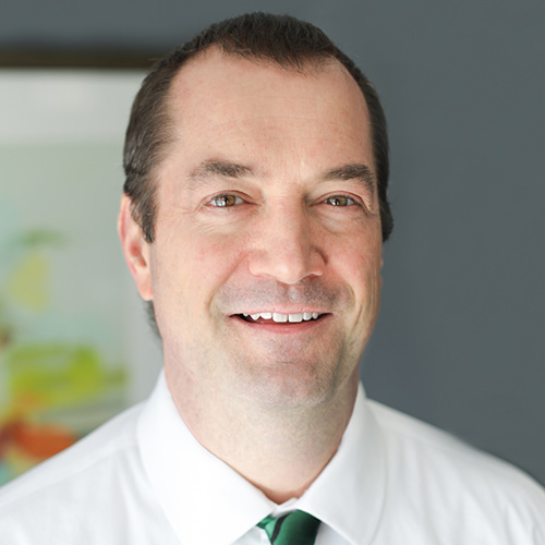 Smiling man in white shirt