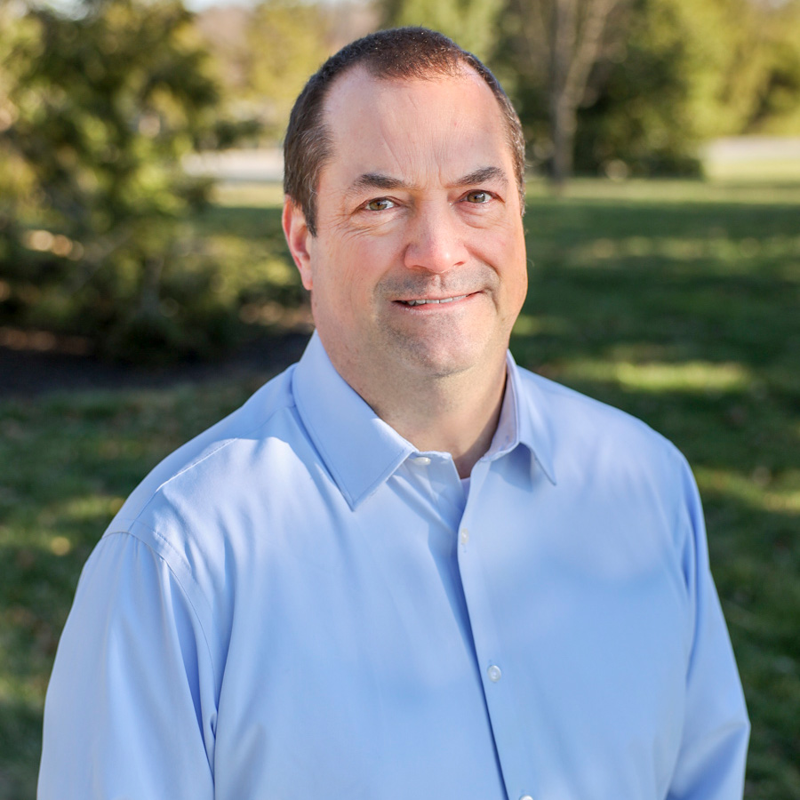 smiling man in blue shirt